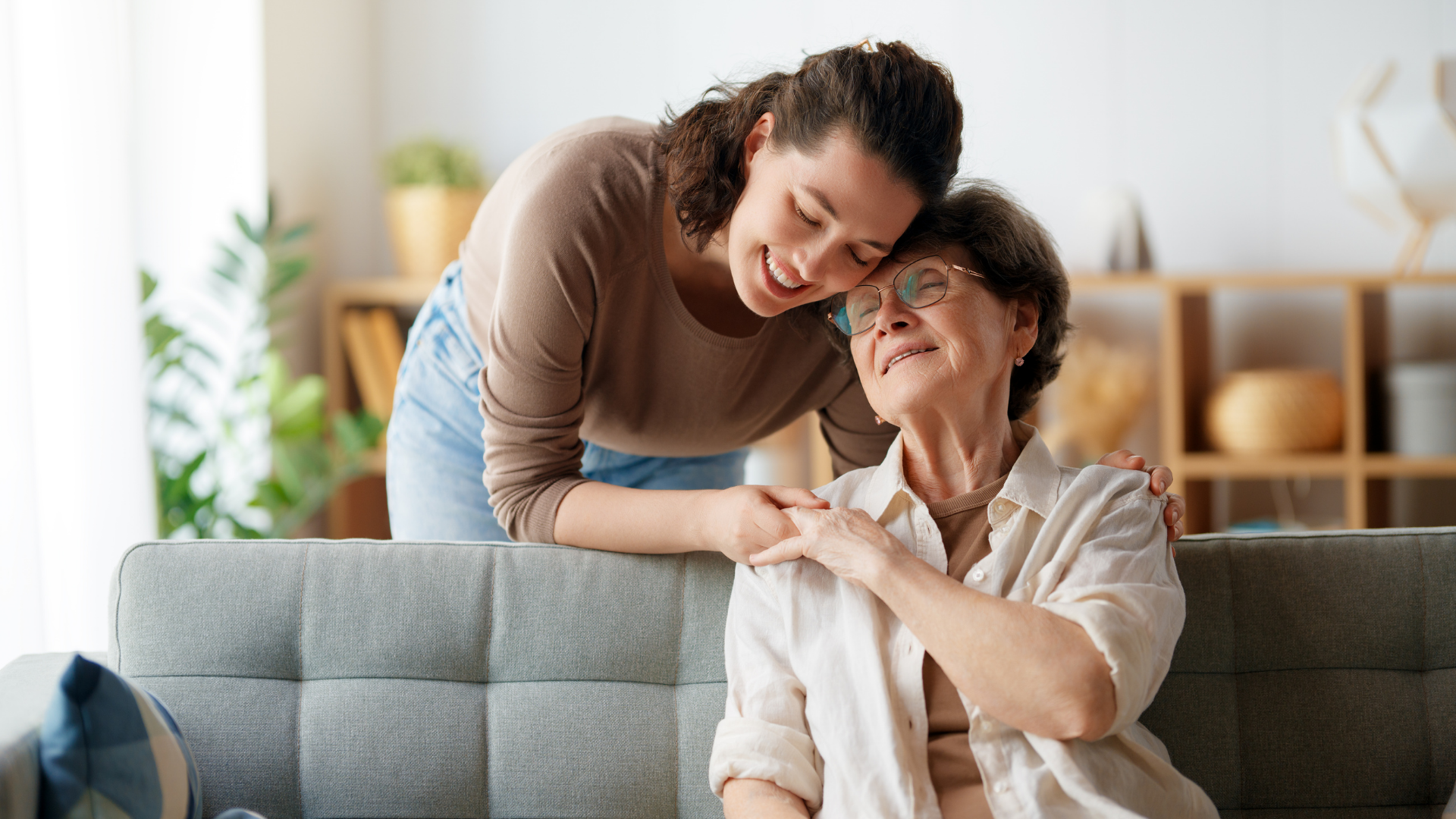 caregiver giving a senior woman a hug