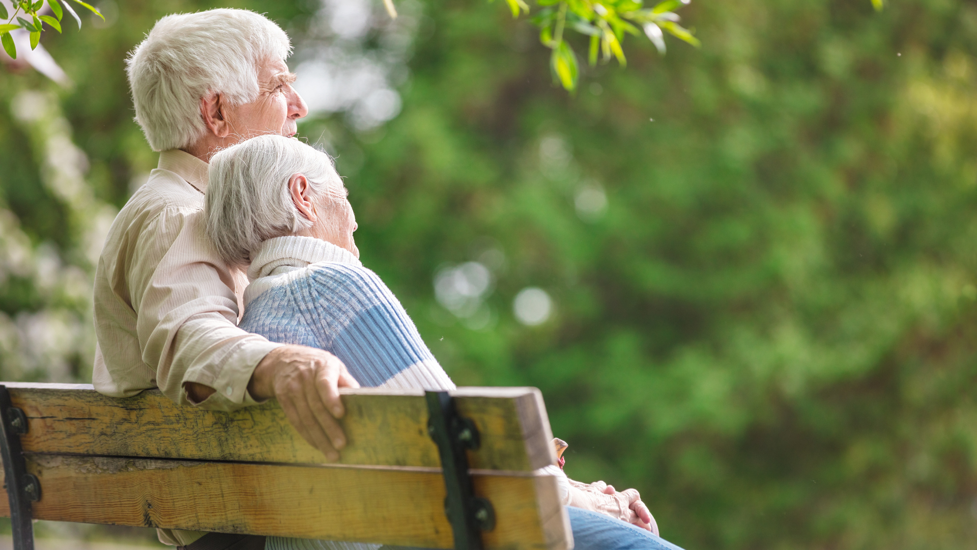 elderly couple sitting on a bench