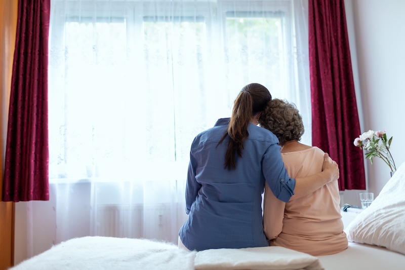 nurse hugging elderly woman