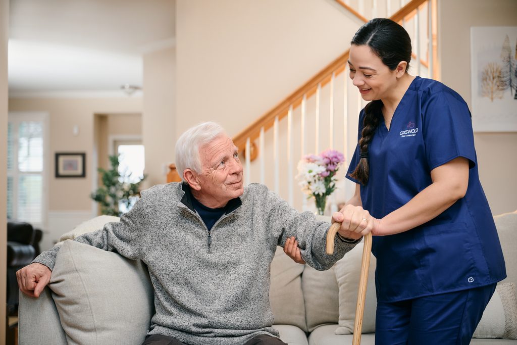 Caregiver supporting senior client during overnight home care.