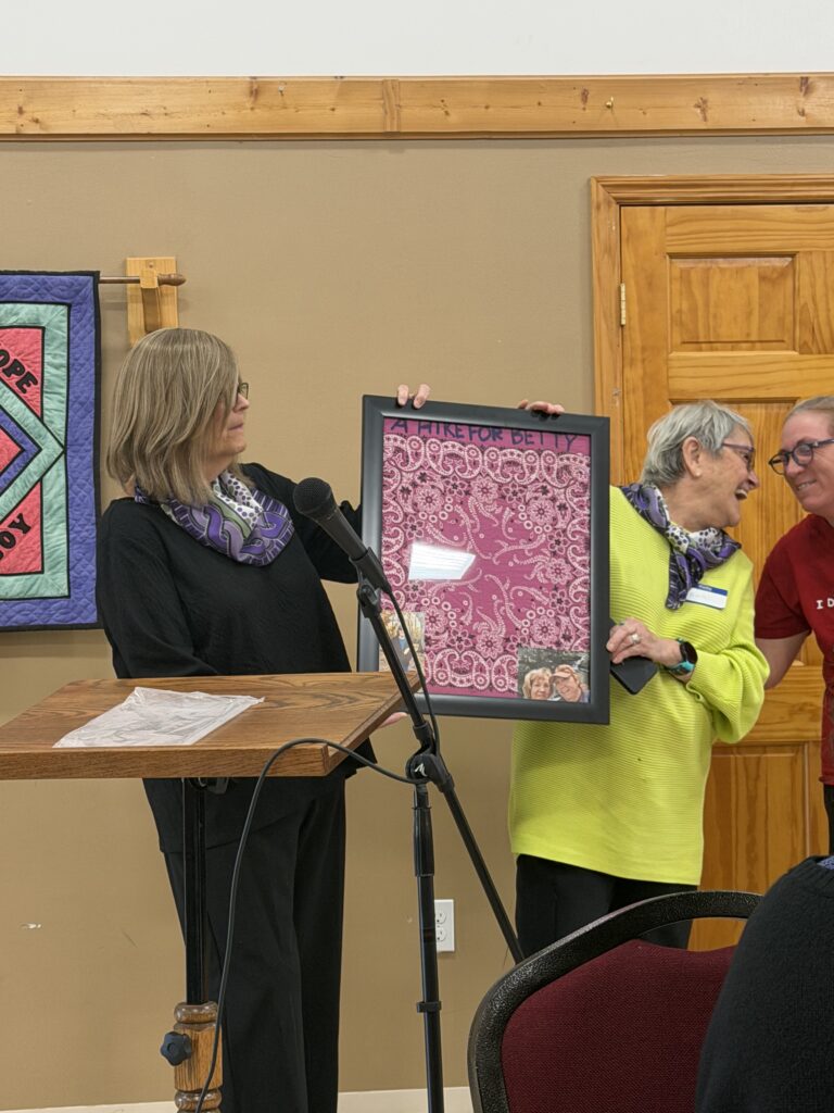 Pictured left to right: Barbara Van Nortwick, Conni Deligo, and Tracey Lassett with Tracey's pink handkerchief