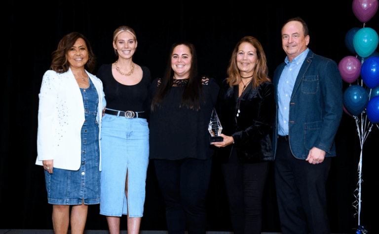 A group picture from Griswold's 2025 conference. Our Director, Kelly Howard, is standing with Jessica Howard, along with Michael Slupecki, Chief Executive Officer of Griswold, and Katherine Schiavino, Griswold's Chief Financial Officer.