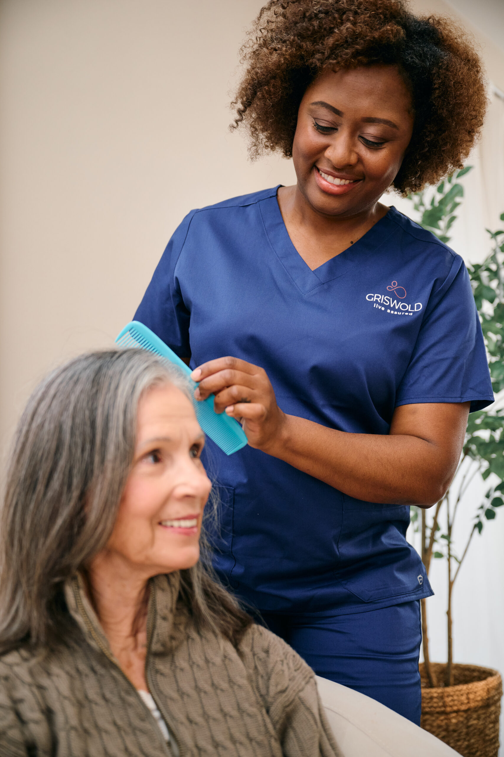 Caregiver combing a client's hair